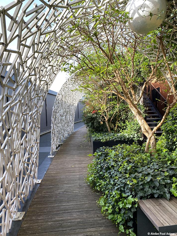 The alcoves create small shaded spaces lined with vegetation.